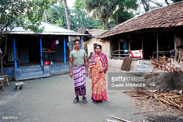 Impoverished Bangladeshi parents of conjoined twins, Lovely Mallick and Kartik Chandra Mallick pose for a photograh at their house in Khulna, some...