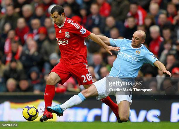 Javier Mascherano of Liverpool is tackled by Stephen Ireland of Manchester City during the Barclays Premier League match between Liverpool and...