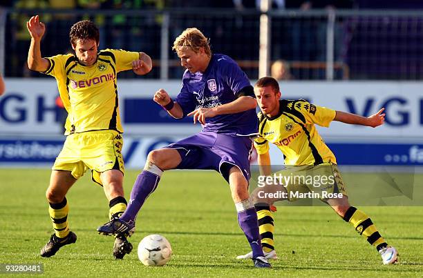 Dennis Schmidt of Osnabruck, Nedim Hasanbegovic and Sebastian Tyrala of Dortmund II battle for the ball during the third Bundesliga match between VfL...