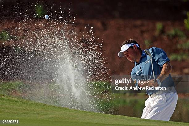 Lee Westwood of England plays from a bunker on the 14th hole during the third round of the Dubai World Championship on the Earth Course, Jumeirah...