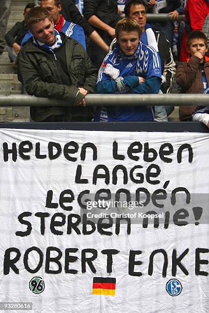 The fans of Schalke show a banner before the Bundesliga match between FC Schalke 04 and Hannover 96 at the Veltins Arena on November 21, 2009 in...