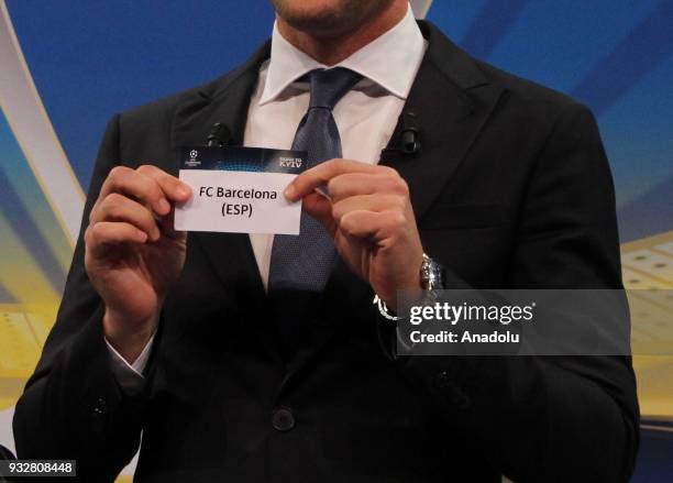 Ukrainian former football player Andriy Shevchenko shows the slip of FC Barcelona during the draw for the quarter finals round of the UEFA Champions...