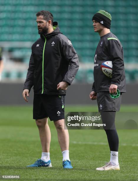 Andy Farrell, the Ireland defence coach talks to Jonathan Sexton during the Ireland captain's run at Twickenham Stadium on March 16, 2018 in London,...