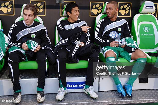 Peter Pekarik, Makoto Hasebe and Ashkan Dejagah of Wolfsburg sit on the substitutes bench prior the Bundesliga match between VfL Wolfsburg and 1. FC...