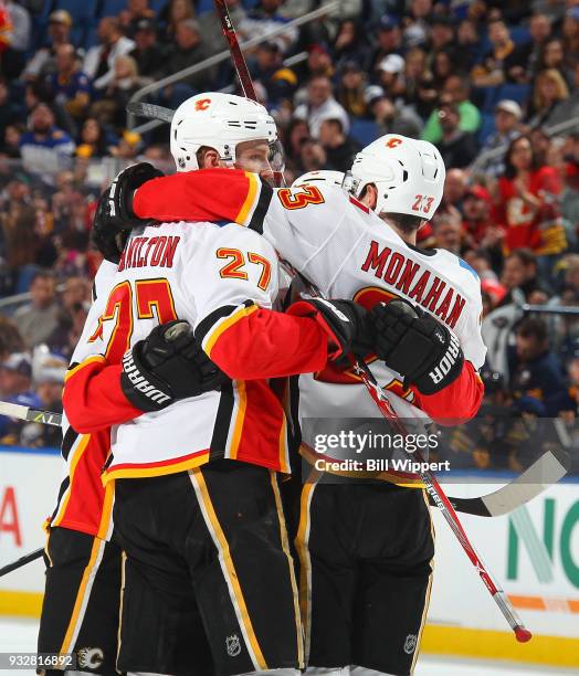 Dougie Hamilton of the Calgary Flames celebrates his goal with Sean Monahan during an NHL game against the Buffalo Sabres on March 7, 2018 at KeyBank...