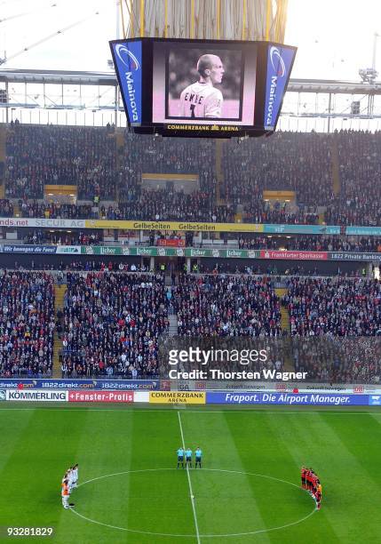 Players of both teams stand up for a minute of silence in remembrance of Robert Enke in prior to the during the Bundesliga match between Eintracht...