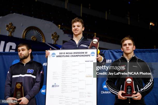 Ben Brisman, of Ithaca, center, who finished first in the 141 weight class, is joined on the podium by Brett Maligner, of Stevens, right, and Chris...
