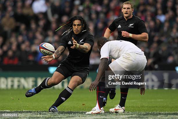 Ma'a Nonu of New Zealand passes as Ayoola Erinle of England closes in during the Investec Challenge Series match between England and New Zealand at...