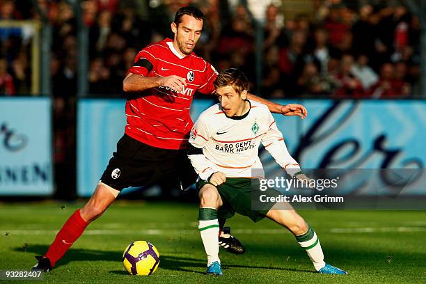 Marko Marin of Bremen is challenged by Pavel Krmas of Freiburg during the Bundesliga match between SC Freiburg and Werder Bremen at the Badenova...