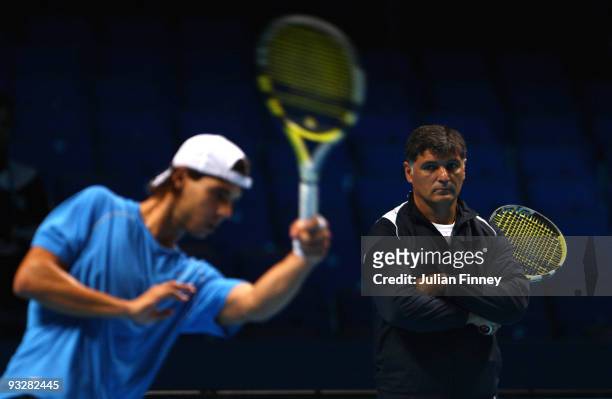 Rafael Nadal of Spain in action as coach and uncle Toni Nadal watches on in a practice session during the Barclays ATP World Tour Finals - previews...