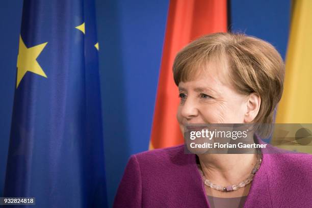 German Chancellor Angela Merkel is pictured after a press conference in front of the flags of the European Union and Germany on March 16, 2018 in...