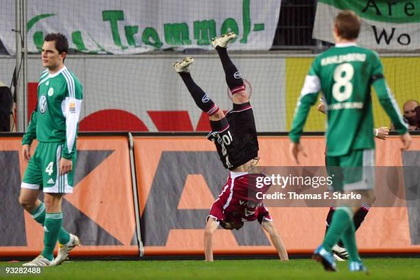 Albert Bunjaku of Nuernberg celebrates his first goal while Marcel Schaefer and Thomas Kahlenberg of Wolfsburg look on during the Bundesliga match...