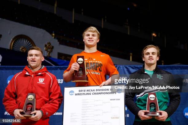 Cross Cannone, of Wartburg, center, who won first place in the 149 weight class, is joined on the podium by Gregory Warner, of York, right, and Evan...