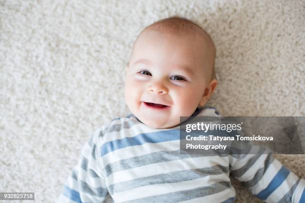 cute portrait of toddler baby boy in sunny roomm sweet baby boy, smiling at camera, close portrait - baby boys stock pictures, royalty-free photos & images