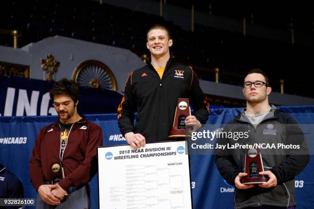 Kyle Fank, of Wartburg, center, who finished first in the 285 weight class, is joined on the podium by Patron, of Loras, right, and Wesley Schultz,...