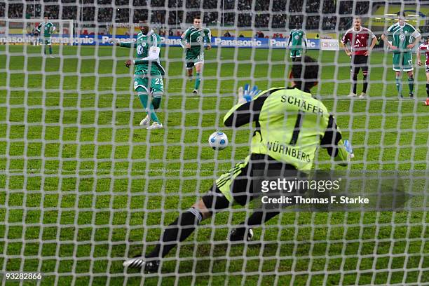 Grafite of Wolfsburg scores through a penalty against goalkeeper Raphael Schaefer of Nuernberg during the Bundesliga match between VfL Wolfsburg and...
