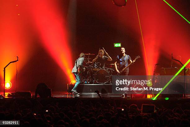 Matthew Bellamy, Dominic Howard and Christopher Wolstenholme perform on stage at Olympiahalle on November 20, 2009 in Munich, Germany.