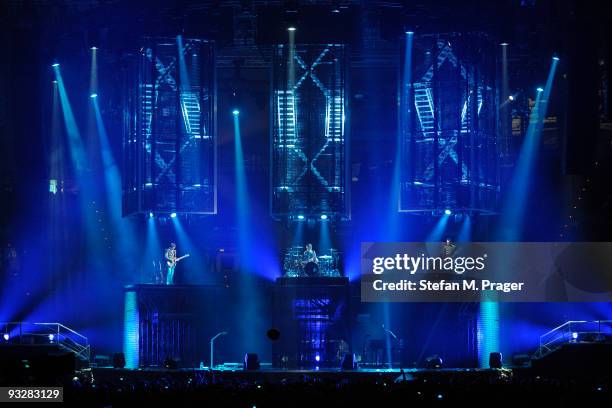 Matthew Bellamy, Dominic Howard and Christopher Wolstenholme perform on stage at Olympiahalle on November 20, 2009 in Munich, Germany.