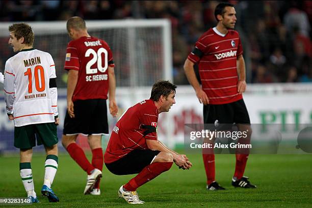 Pavel Krmas, Heiko Butscher and Ivica Banovic of Freiburg react next to Marko Marin of Bremen after the Bundesliga match between SC Freiburg and...