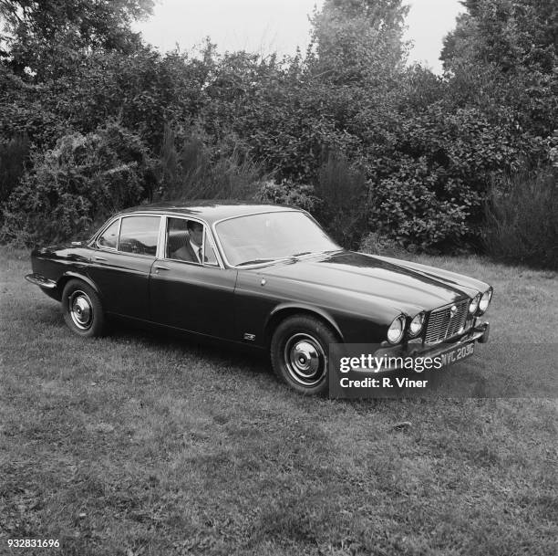 Man sitting inside a Jaguar XJ6 Series 1, UK, 24th September 1968.