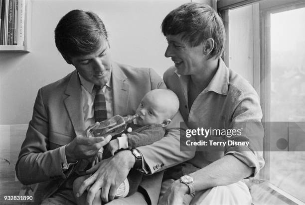 British actor and television presenter Peter Purves, holding 14-week-old Daniel Scott, with British television presenter John Noakes , UK, 27th...