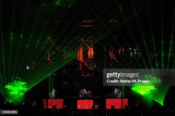 Matthew Bellamy, Dominic Howard and Christopher Wolstenholme perform on stage at Olympiahalle on November 20, 2009 in Munich, Germany.