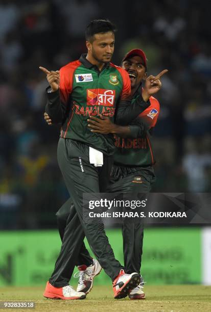 Bangladesh captain Shakib Al Hasan celebrates with teammate Nazmul Islam after dismissing Sri Lanka's Danushka Gunathilaka during the sixth Twenty20...