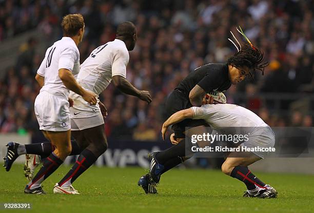 Ma'a Nonu of New Zealand is tackled by Dan Hipkiss of England closes him down during the Investec Challenge Series match between England and New...