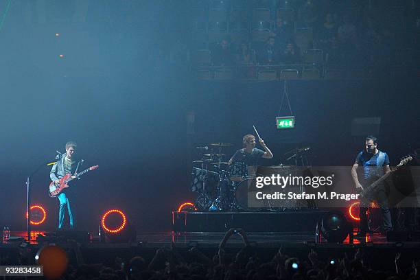 Matthew Bellamy, Dominic Howard and Christopher Wolstenholme perform on stage at Olympiahalle on November 20, 2009 in Munich, Germany.