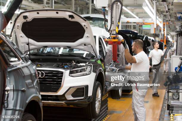 Car production at Audi AG in Ingolstadt. Installation of the front seats on the Audi A3/Q2,