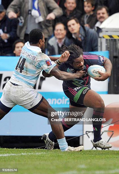 Stade Francais's number 8 Mathieu Bastareaud powers his way to score a try despite Racing Metro's Sereli Bobo and Francois Steyn during French Top 14...