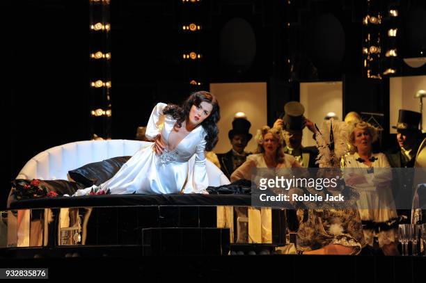Claudia Boyle as Violetta Valery with artists of the company in English National Opera's production of Giuseppe Verdi's La traviata directed by...