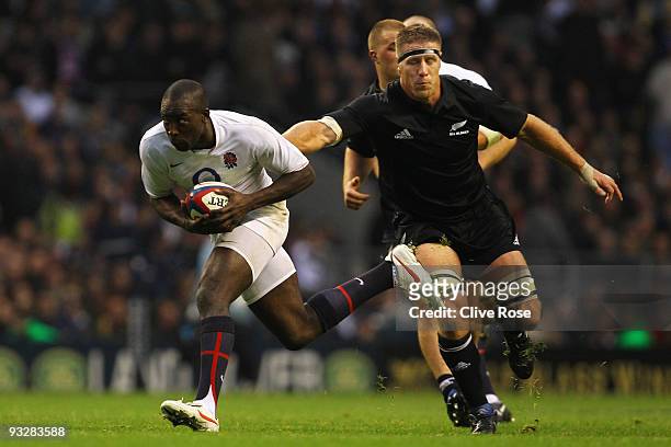 Ayoola Erinle of England sprints away from Brad Thorn of New Zealand during the Investec Challenge Series match between England and New Zealand at...