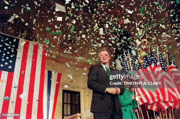 Democratic presidential candidate Bill Clinton reacts with his wife Hillary as confetti reigns down during his victory party after winning the...