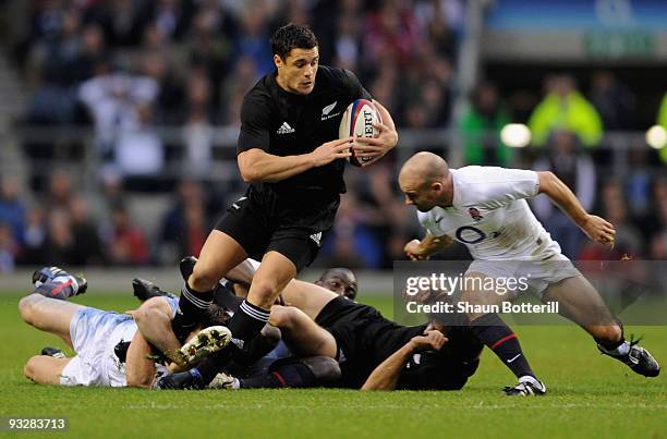 Dan Carter of New Zealand evades a tackle but is closed down by Paul Hodgson of England during the Investec Challenge Series match between England...