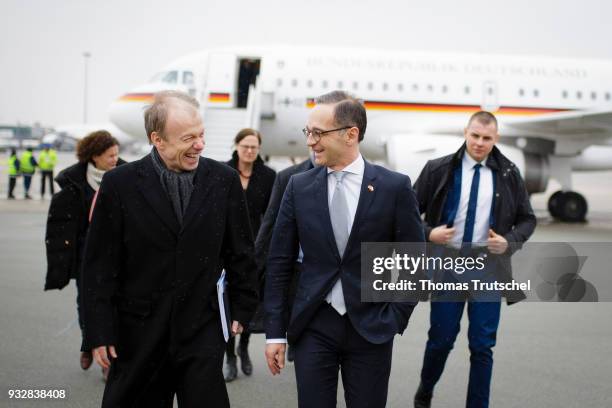 German Foreign Minister and Vice Chancellor Heiko Maas R) chats with german ambassador Rolf Nikel after his arrival at Warsaw Airport on October 16,...