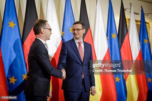 German Foreign Minister and Vice Chancellor Heiko Maas shakes hands with Prime Minister of Poland Mateusz Morawiecki on October 16, 2018 in Warsaw,...