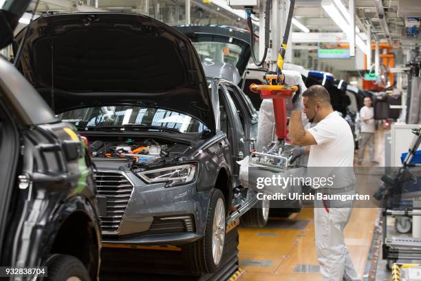 Car production at Audi AG in Ingolstadt. Installation of the front seats on the Audi A3/Q2,