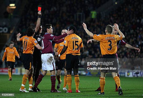 Bernard Mendy of Hull is sent off by referee Mark Clattenburg for a peofessional on Scott Parker of West Ham during the Barclays Premier League match...