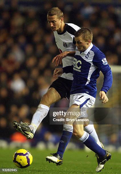 Sebastian Larsson of Birmingham City is tackled by Brede Hangeland of Fulham during the Barclays Premier League match between Birmingham City and...