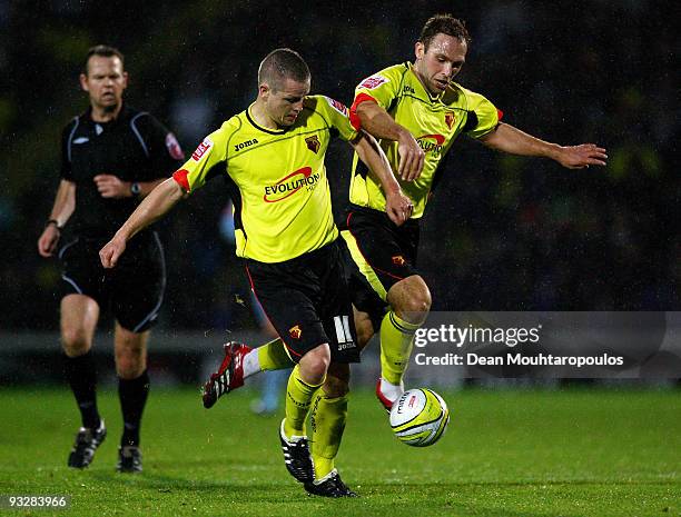 Team mates Heidar Helguson and John Eustace of Watford go for the ball as referee Christopher Sarginson looks on during the Coca Cola Championship...