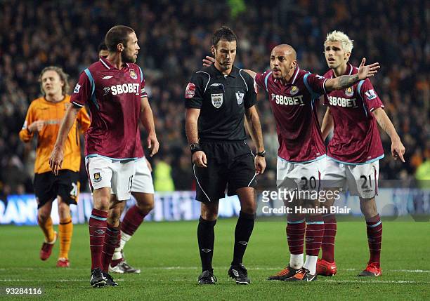 Julien Faubert of West Ham leads his team mates in protesting to referee Mark Clattenburg after Hull were awarded a penalty which led to their third...