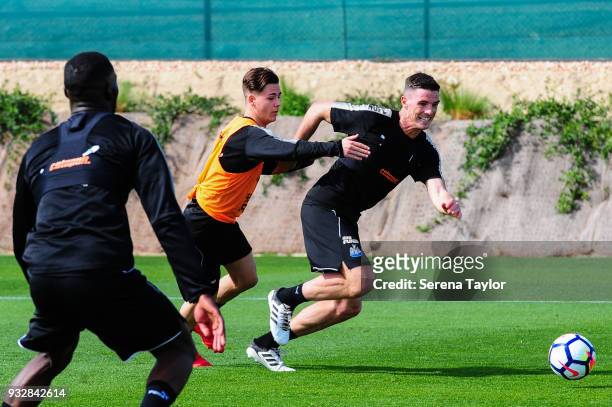 Ciaran Clark races a trailing Victor Fernandez for the ball during the Newcastle United Training Session at Hotel La Finca on March 16 in Alicante,...