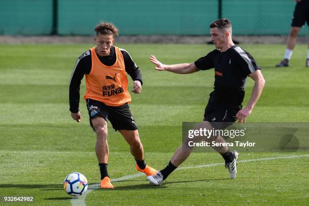 Dwight Gayle passes the ball whilst Ciaran Clark challenges during the Newcastle United Training Session at Hotel La Finca on March 16 in Alicante,...