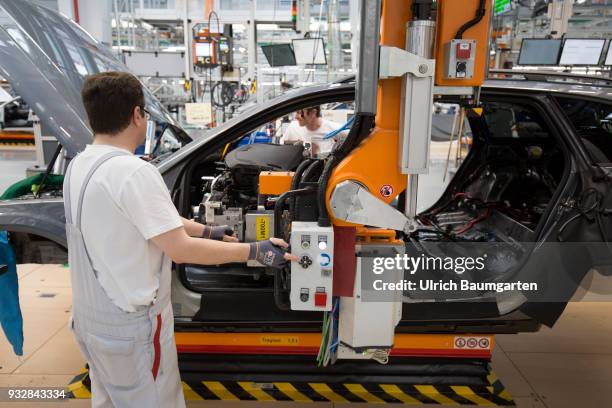 Car production at Audi AG in Ingolstadt. Installation of the pre-assembled cockpits into the Audi cars A4/A5.