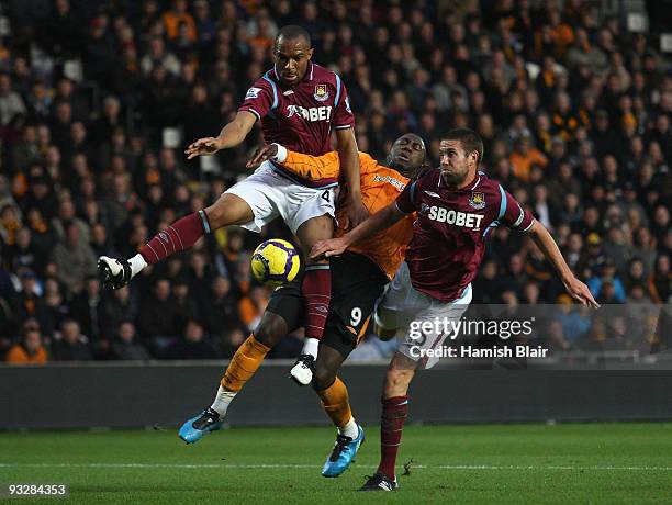 Jozy Altidore of Hull contests with Danny Gabbidon and Matthew Upson of West Ham during the Barclays Premier League match between Hull City and West...