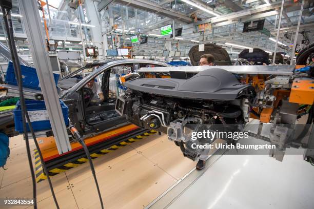 Car production at Audi AG in Ingolstadt. Installation of the pre-assembled cockpits into the Audi cars A4/A5.