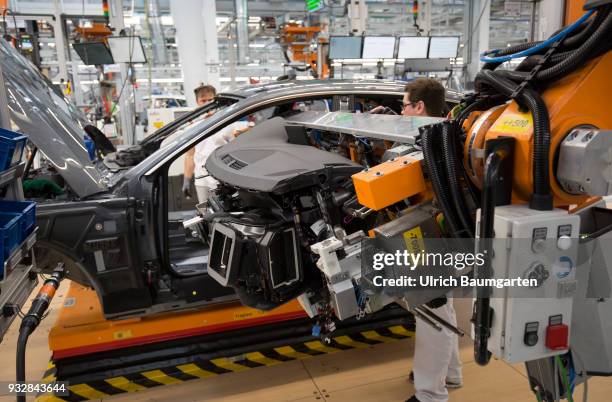 Car production at Audi AG in Ingolstadt. Installation of the pre-assembled cockpits into the Audi cars A4/A5.