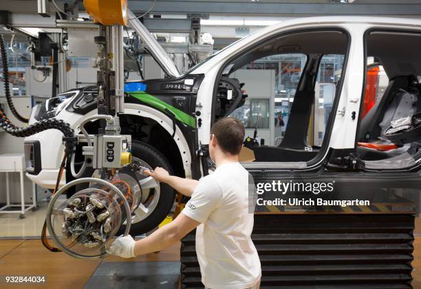 Car production at Audi AG in Ingolstadt. Wheel assembly on the Audi A3/Q2.