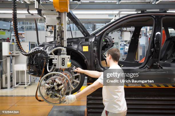 Car production at Audi AG in Ingolstadt. Wheel assembly on the Audi A3/Q2.